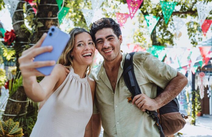 Hispanic,Young,Couple,Taking,Photo,Selfie,On,Vacations,Or,Holidays